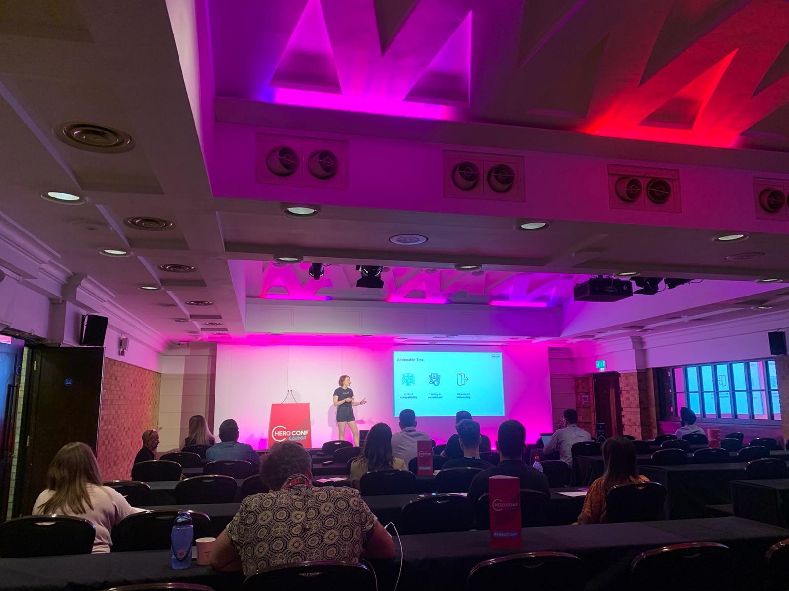 Sarah Clarke speaking on stage at hero conference